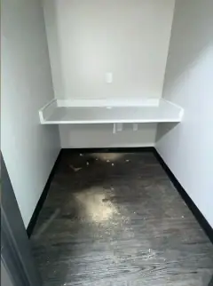 Small new commercial alcove with a dusty, streaked floor