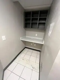 Same room after the final clean, with clean tile floor and shelf