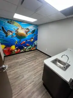 Same room after the final clean, with a clean floor, counter and sink