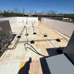New commercial rooftop with construction dust and stains on the roof membrane around the HVAC units