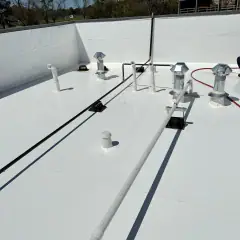 Same rooftop vents and piping on a clean white membrane