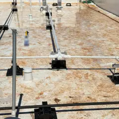 Rooftop vents and piping with construction dust and stains on the membrane