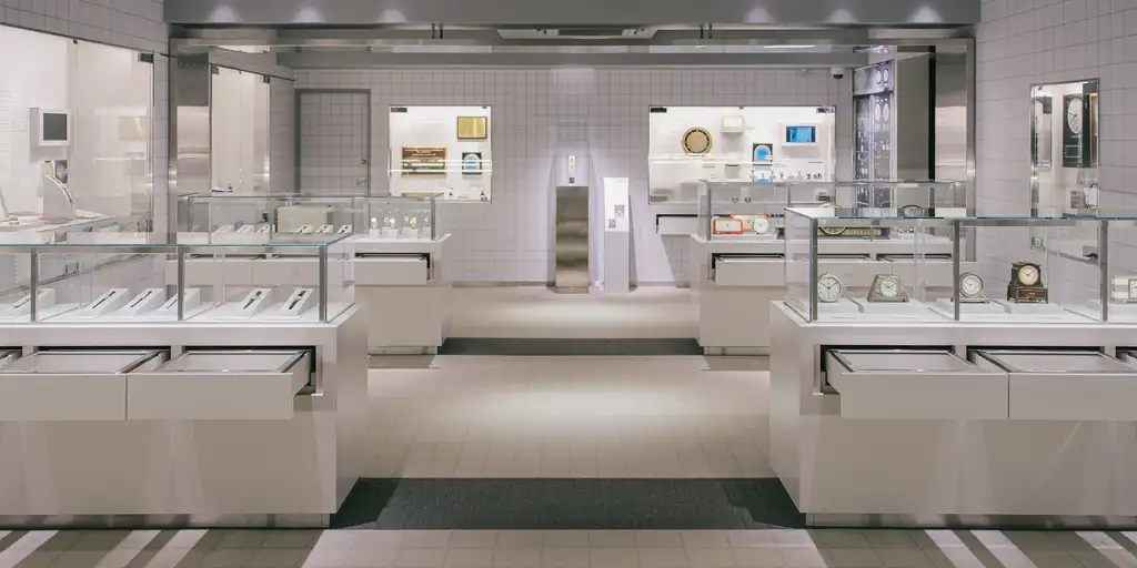 Spotless, newly fitted retail store with white display counters, glass cases and a tiled floor