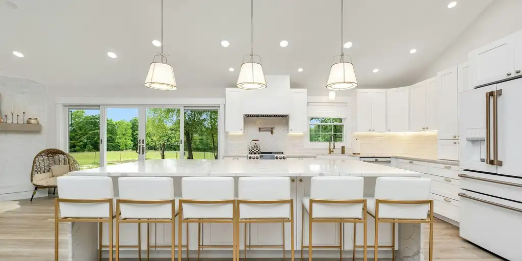 Clean white kitchen with a large island