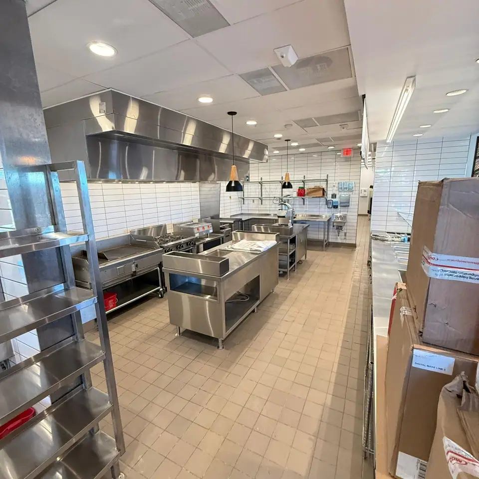 Commercial kitchen with stainless steel equipment cleaned after construction
