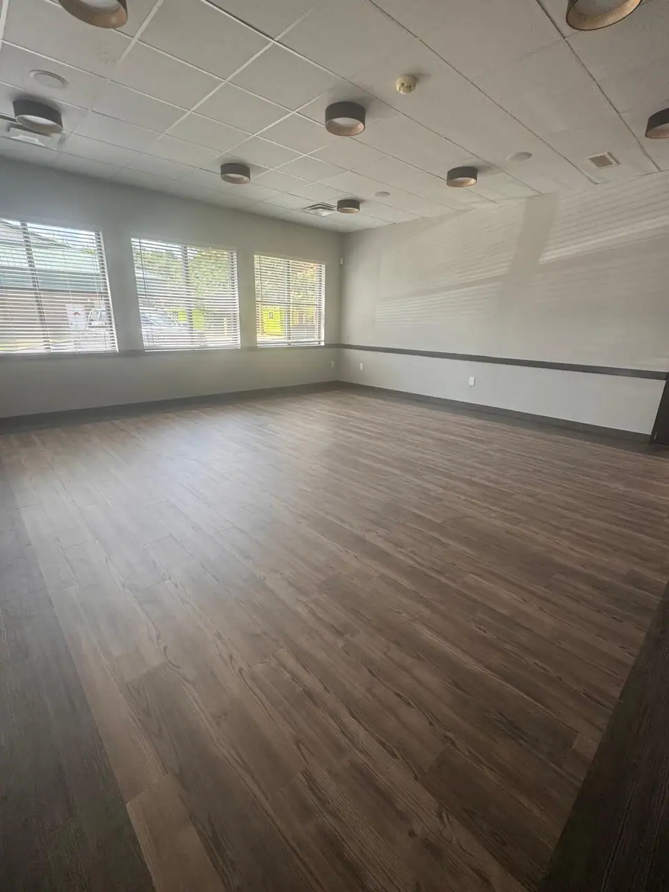 Empty office space with windows and floors cleaned
