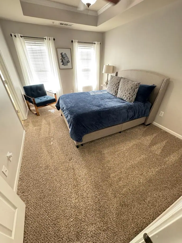 Freshly cleaned bedroom with vacuumed carpet